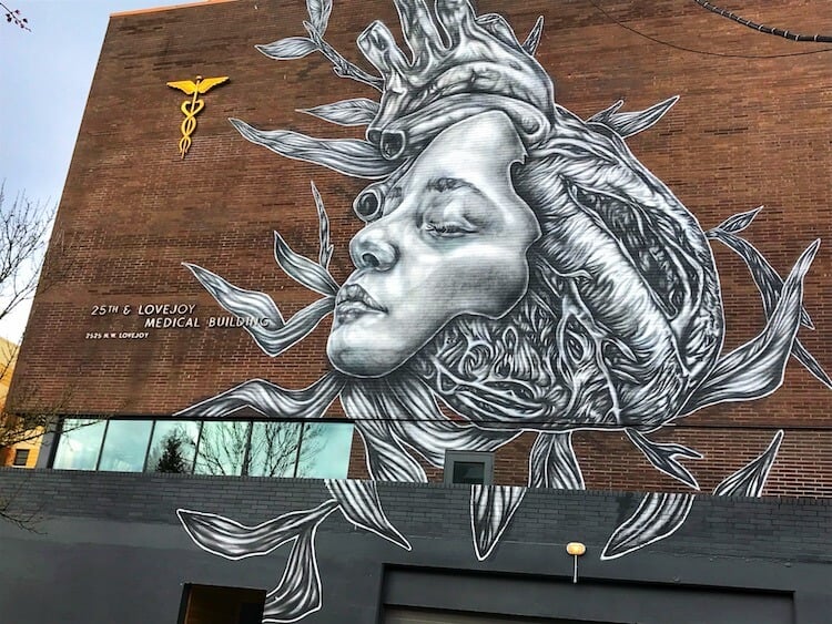 Mural on a brick building of a woman's face