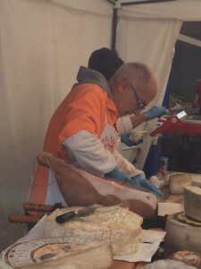 A man cutting cheese