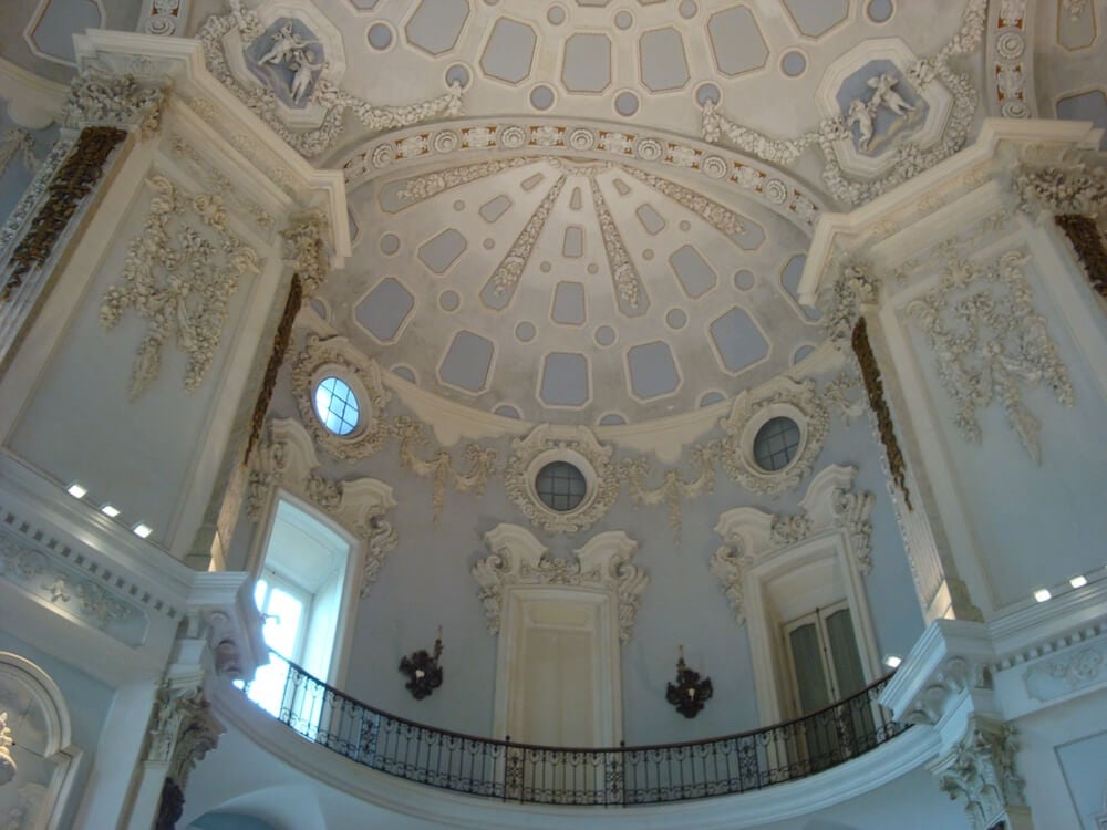 a white rocoo ceiling of the palace on Isola Bela