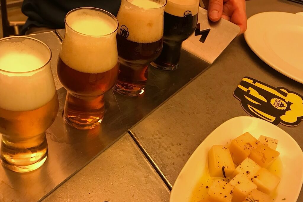 flight of three beers on a table
