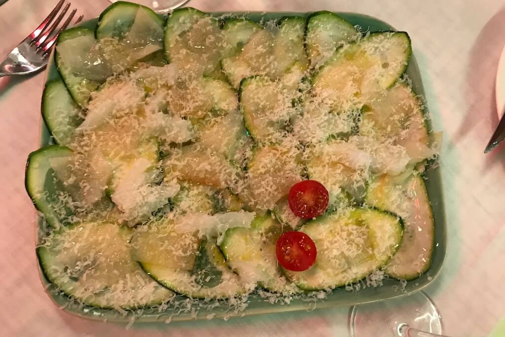 thinly sliced zuccini with shredded codfish and grated cheese