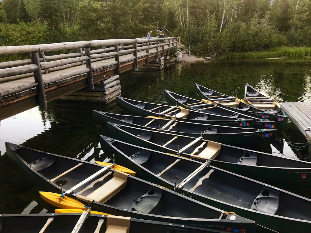 kayaks on a lake with a wooden bridge