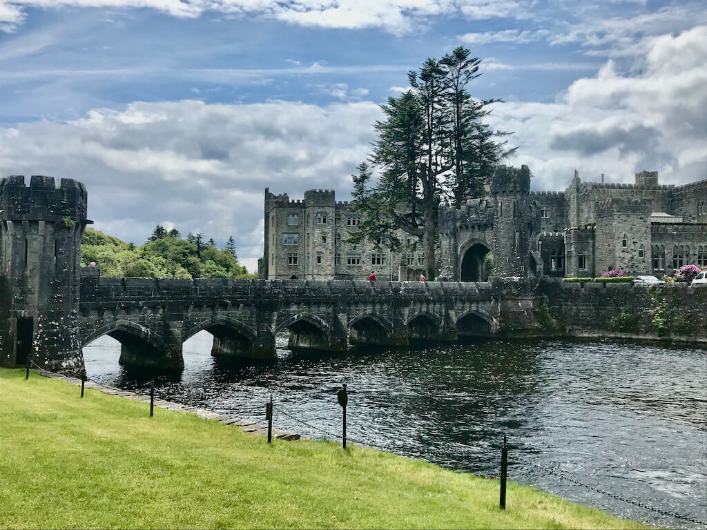 view of stunning Ashford Castle across a river
