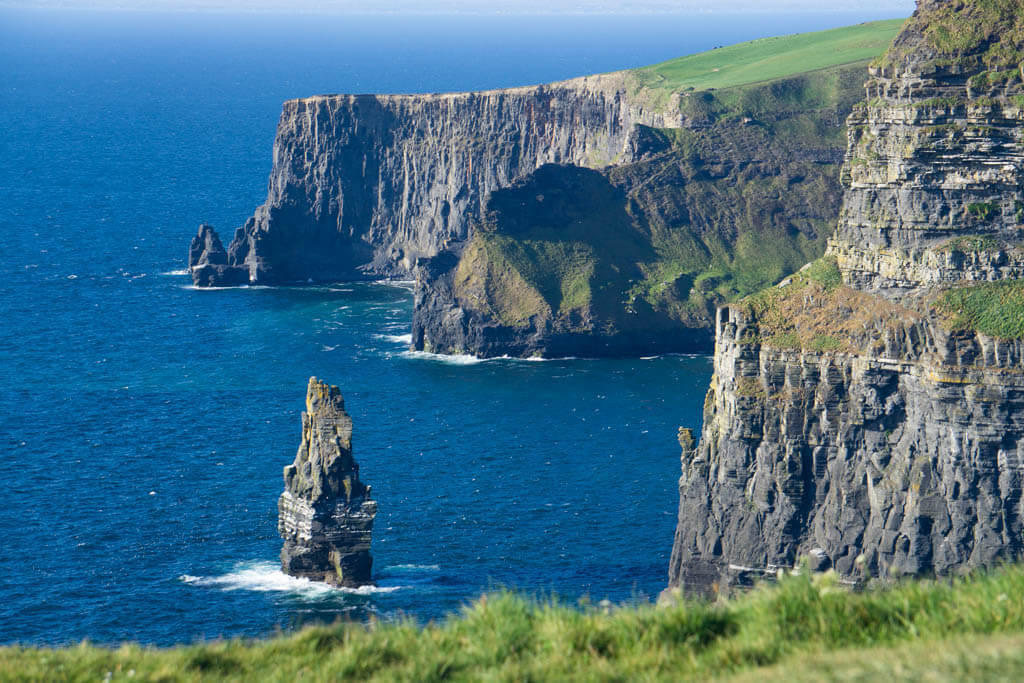 Steep cliffs next to a deep blue sea