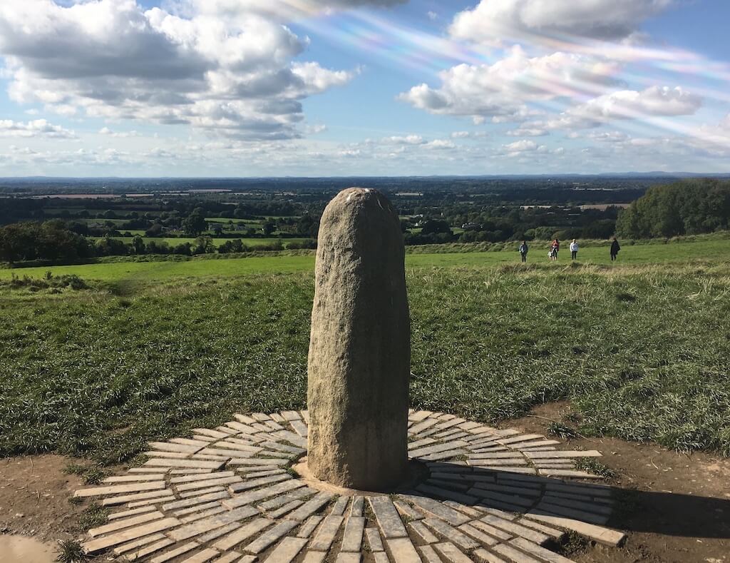 photo of a stone phallus like shape on a hill