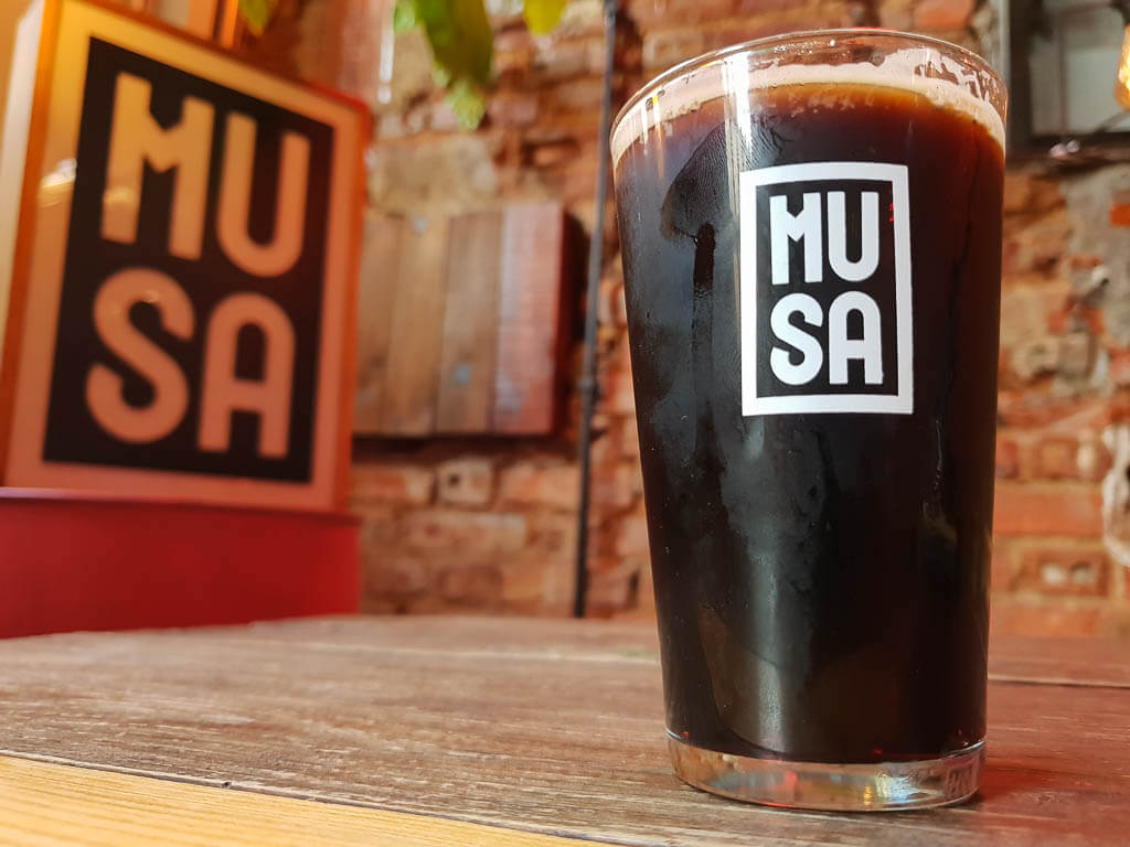dark beer in a glass on a counter