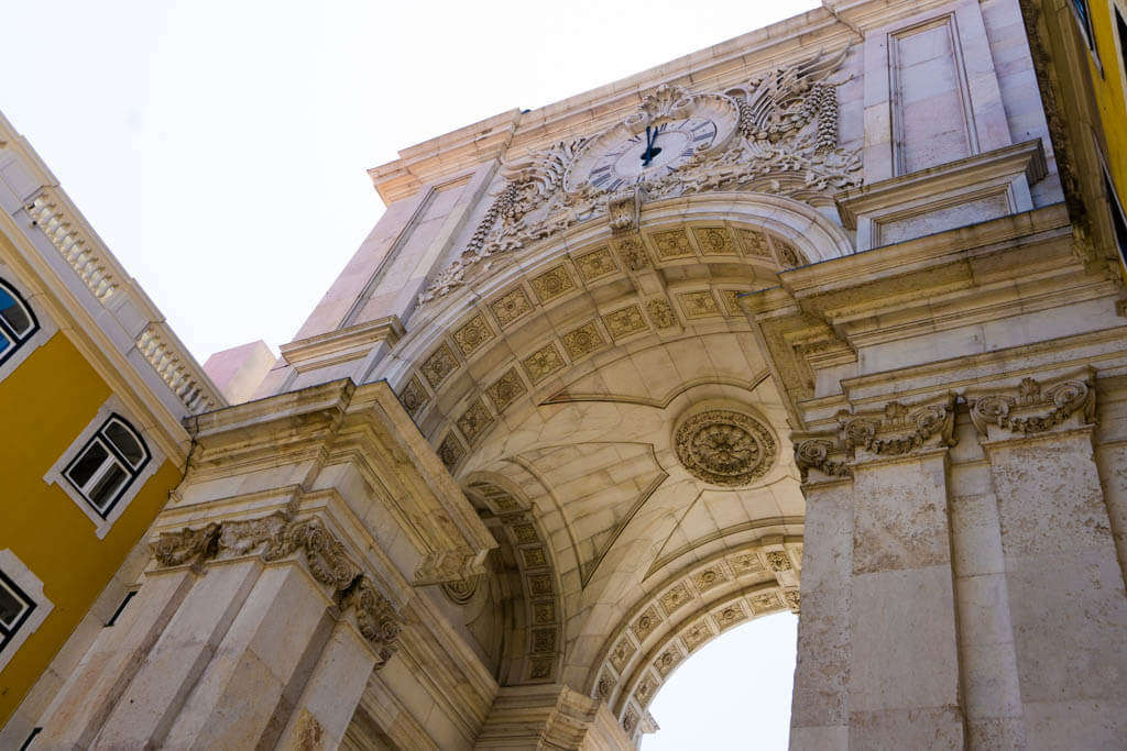 close-up looking up at the bottom of the ornately carved Rua August Arch in Lisbon