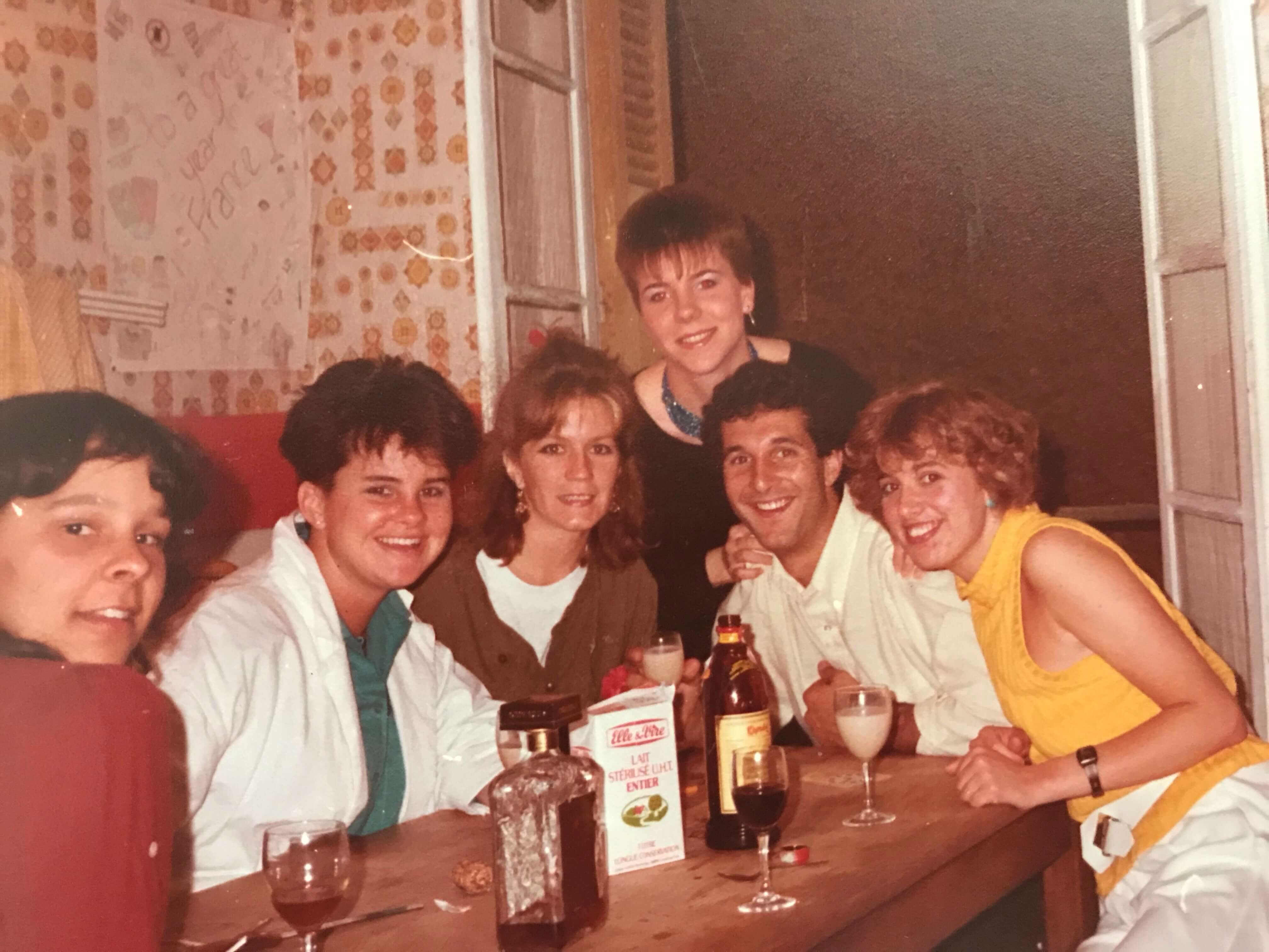 Group of American teenagers around a table with bottles of boozes