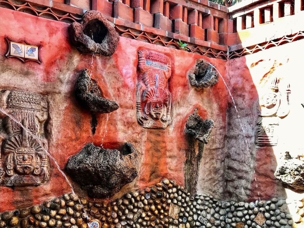 Pink stucco and stone fountain