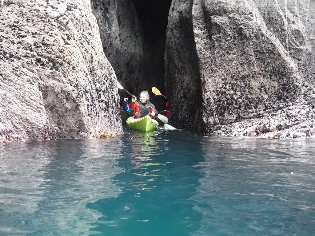 woman kayaking in a sea cave
