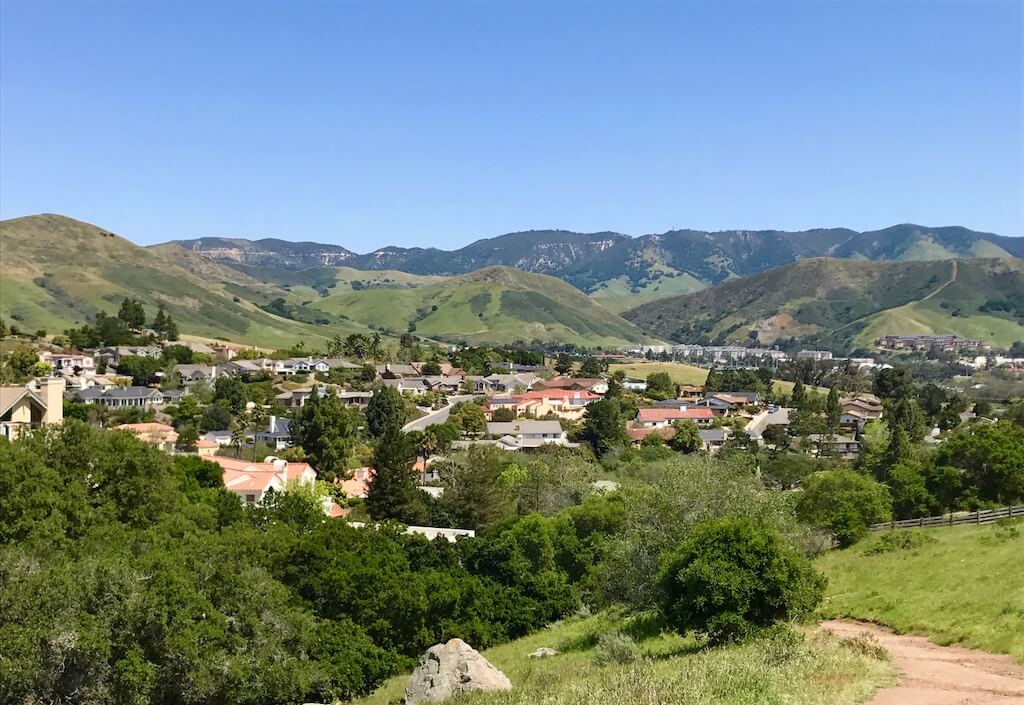 mountains and homes among lush green hills