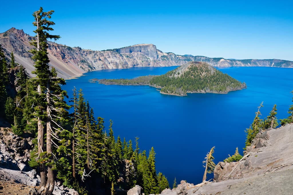 panoramic view of Crater Lake with pine trees