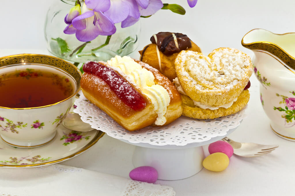 Tea in china cups with pastries