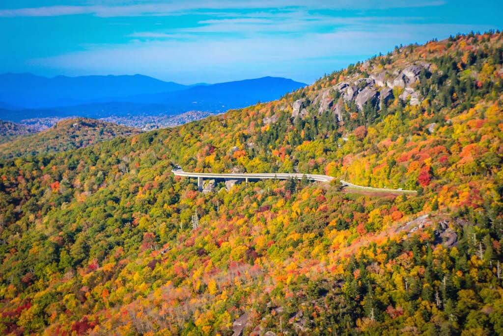 scenic highway snaking through colorful fall trees on a mountain on the Blue Ridge Parkway