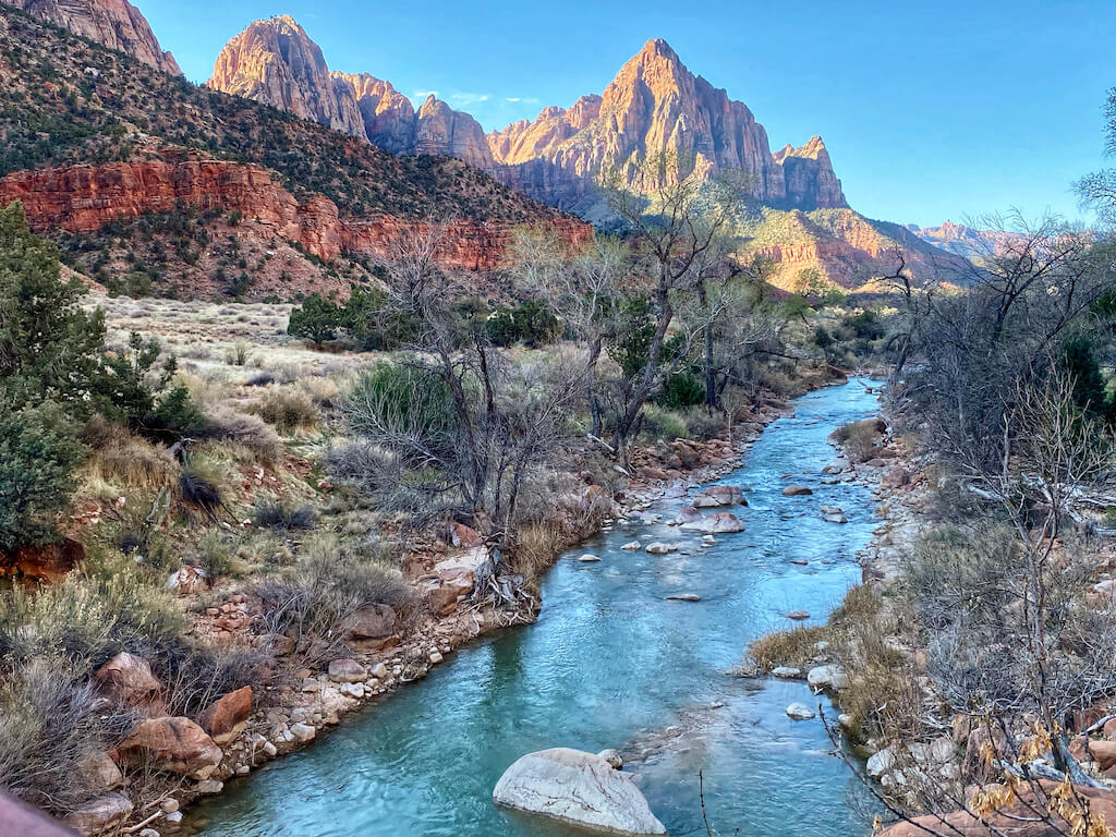 Virgin River in Zion with large sandstone cliffs in background