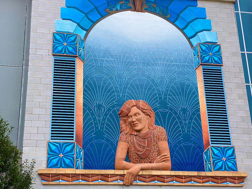mural of a woman looking out a window
