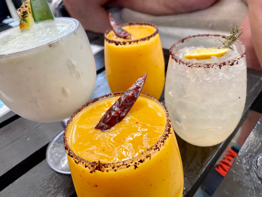 colorful cocktails rimmed with chili