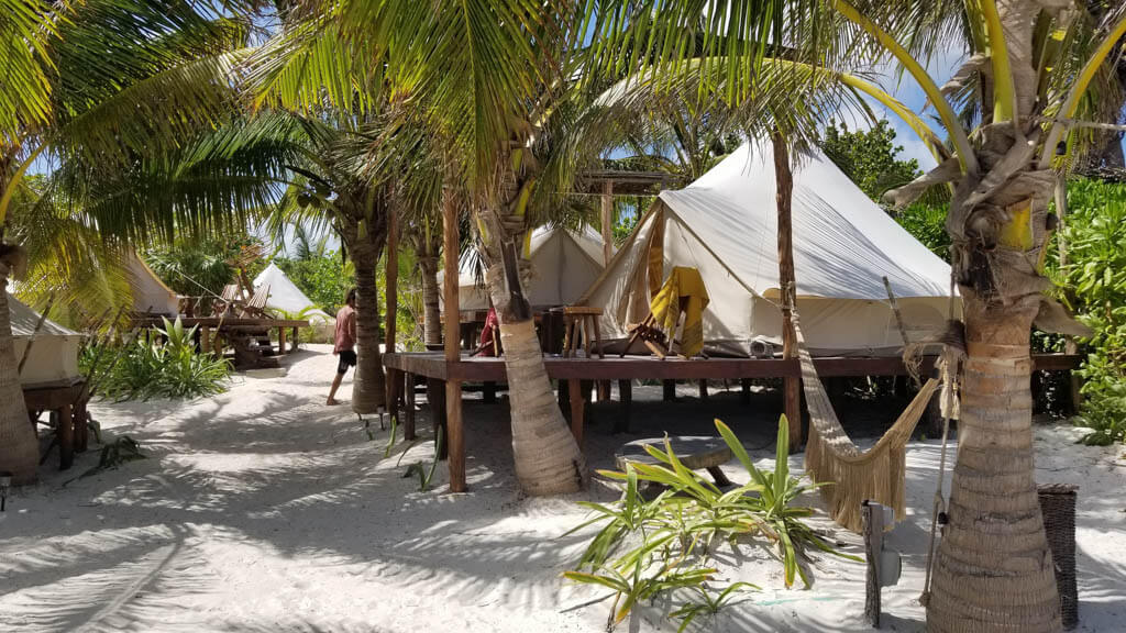 tents on platforms in the soft white sand in Tulum