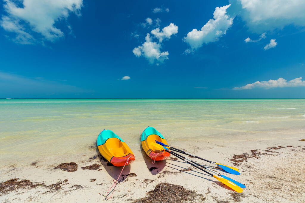 kayaks on pristine sunny tropical beach in Mexico
