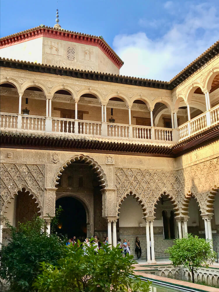 Interior of Alcazar courtyard with ornate architecture