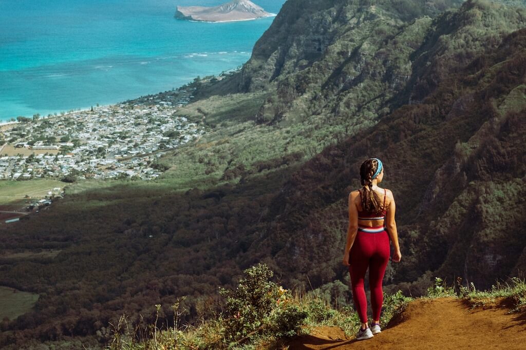 woman looking over valley to the ocean at Kouliouou Ridge, one of the best hikes in Oahu
