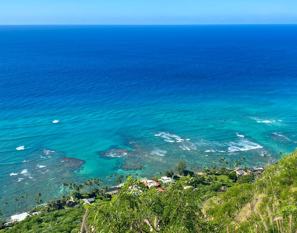 Looking down on bright turquoise ocean from Diamond Head's summit