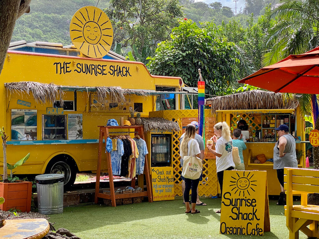 Bright orange food truck. Sign says The Sunrise Shack Organic Cafe