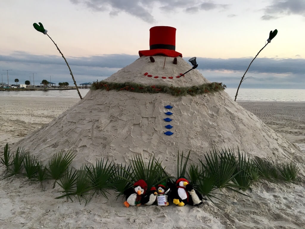 Fat snowman on the beach made out of sand