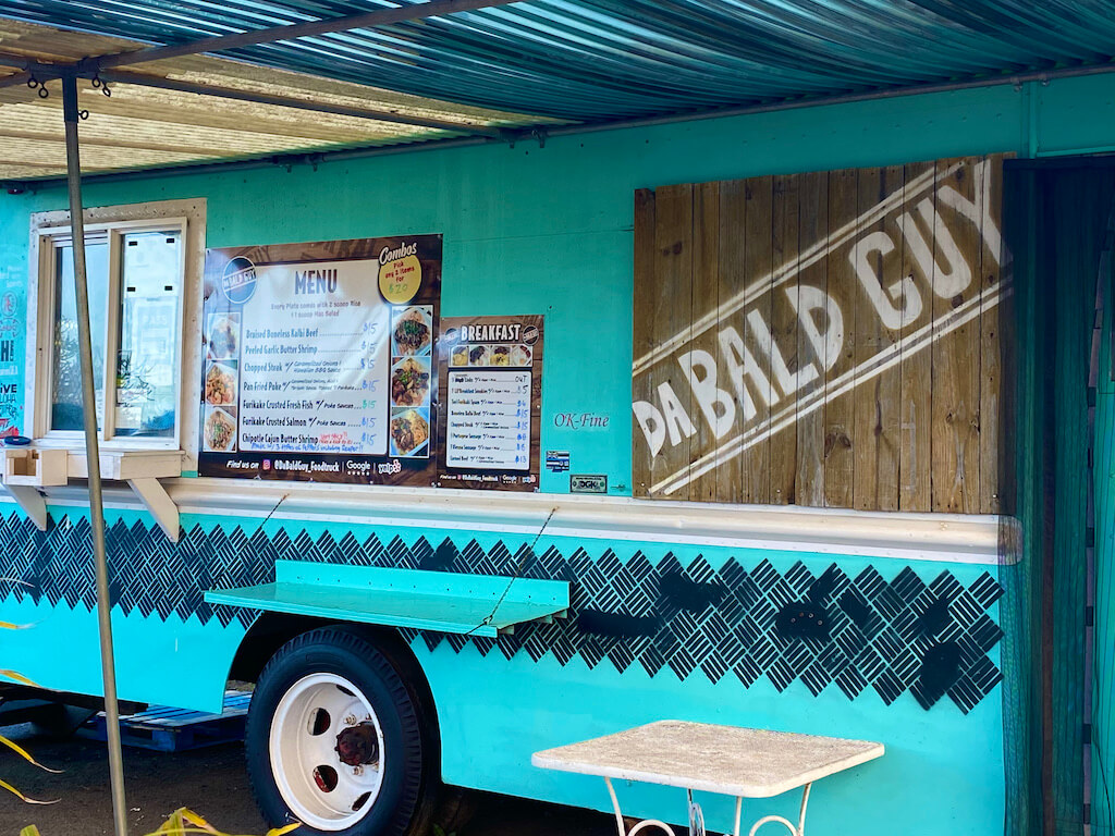 turquoise food truck. Sign says "Da Bald Guy"