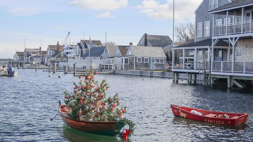 Christmas tree on a brass canoe in the water in Nantucket in December