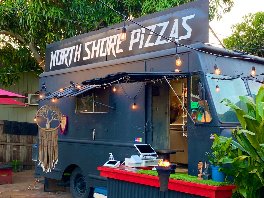 Gun metal gray food truck. Sign says "North Shore Pizzas"