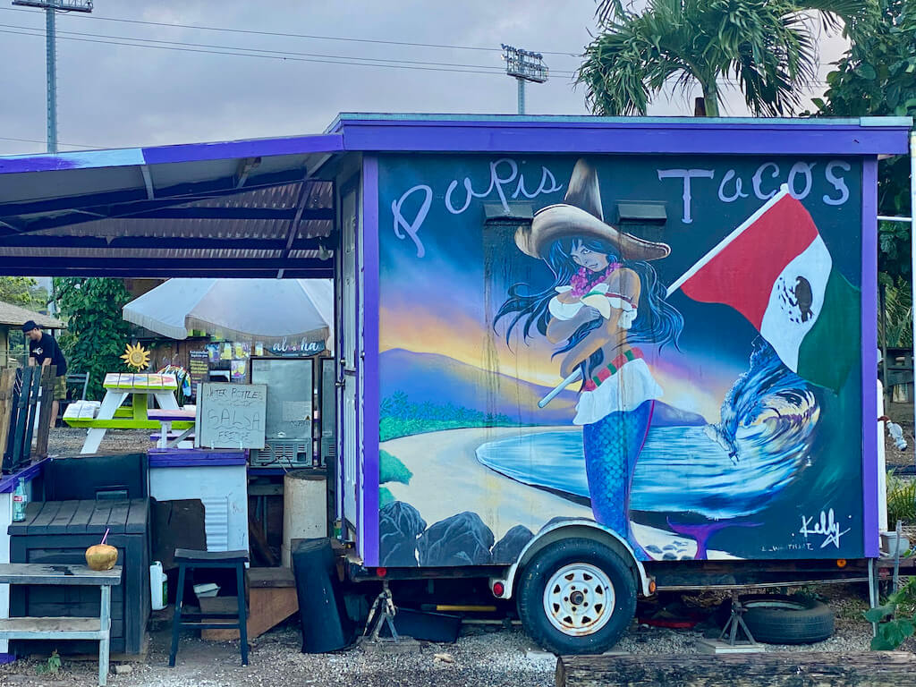 Food truck with mural of Mexican girl at the beach