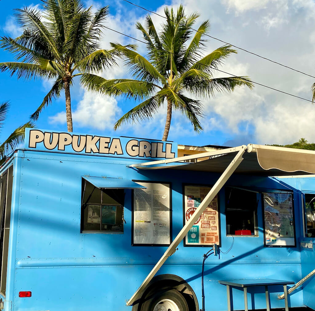 light blue food truck. Sign says Pupukea Grill