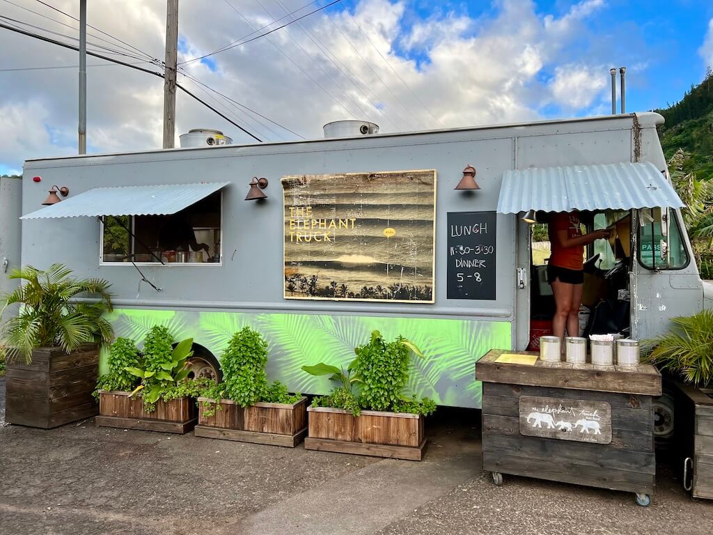 gray and green food truck with sign "The Elephant Shack"