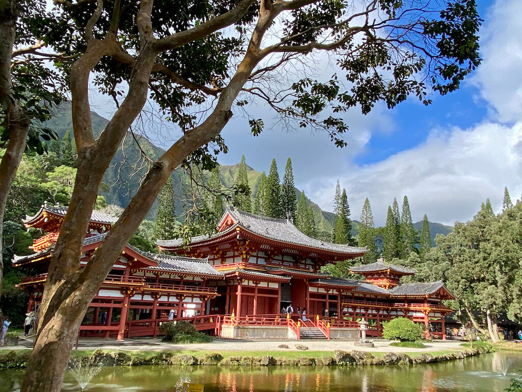 View of Byodo-in-Temple with Koi pond and backdrop of green mountains