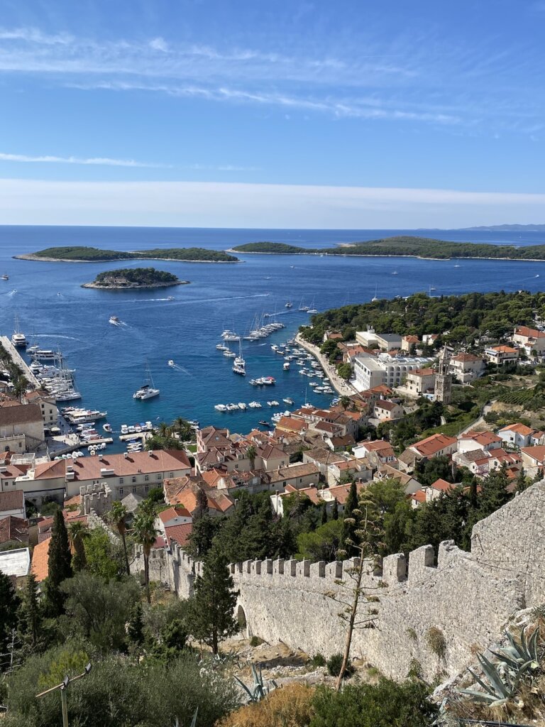 View of town on Hvar by ocean with stone wall