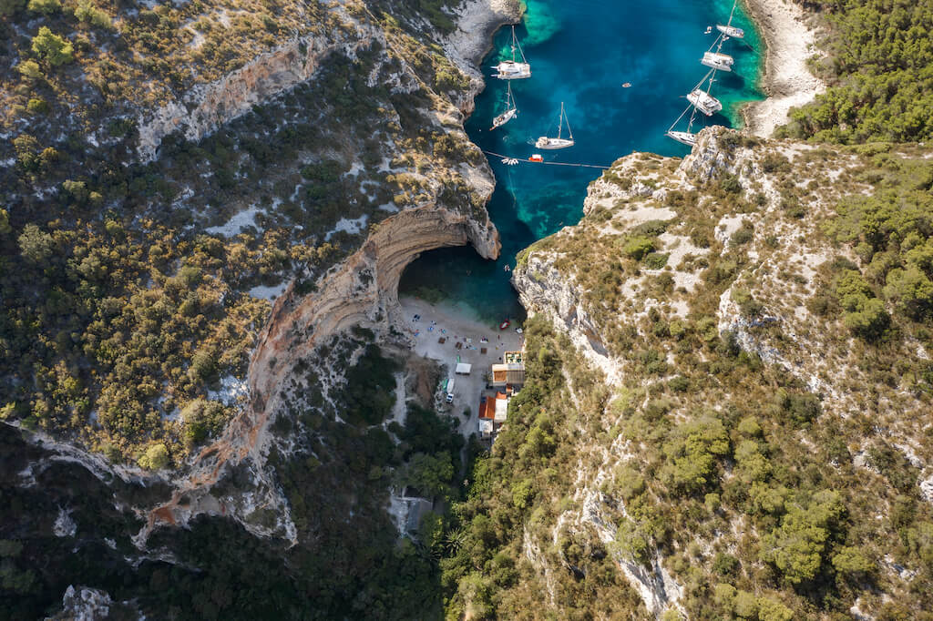 Aerial drone shot of iconic Stiniva cove beach of Adriatic sea on Vis Island in Croatia summer morning
