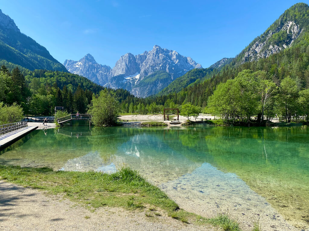Green lake with alps in the background