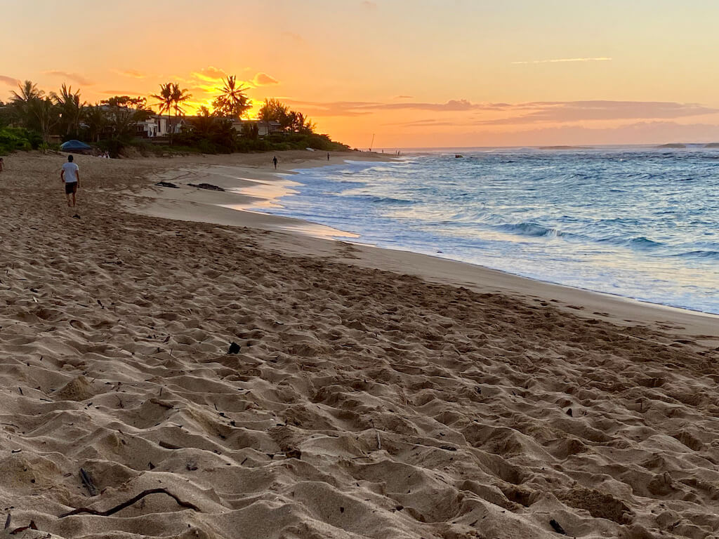bright orange sunset over the beach on north shore Oahu