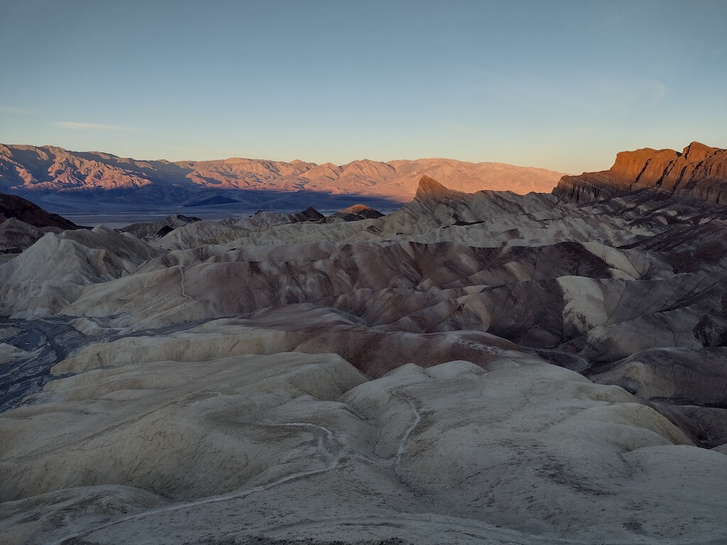 View over surrounding mountains into Death Valley at sunset