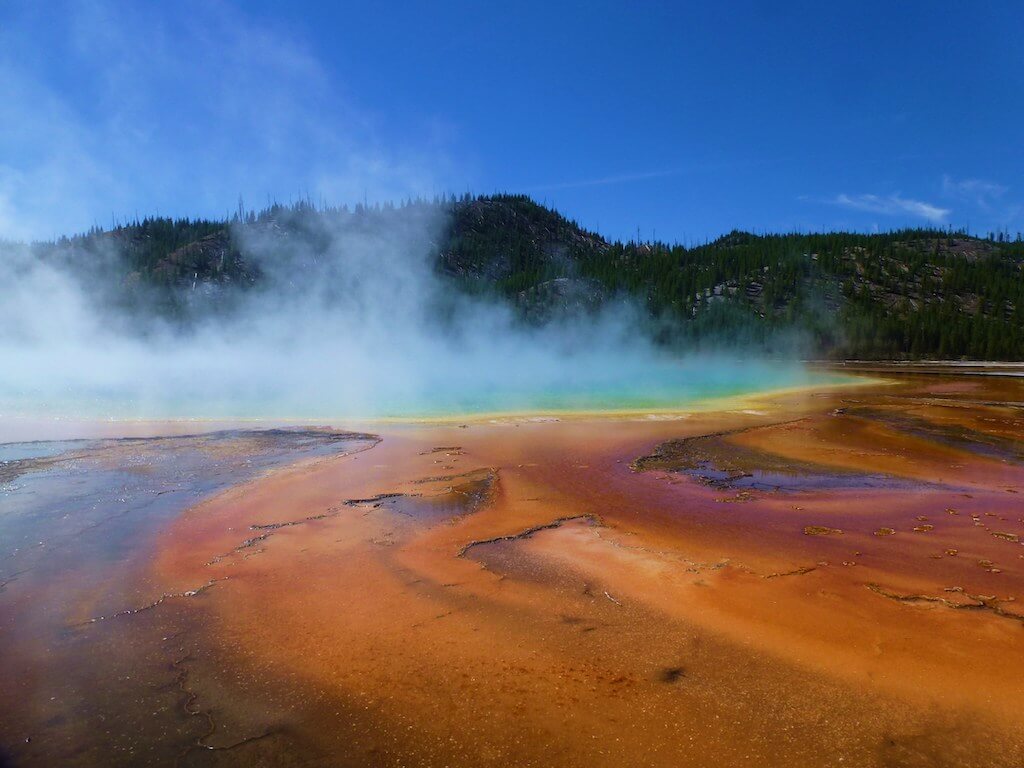 view of Grand Prismatic Spring showing colors on the water and steam rising