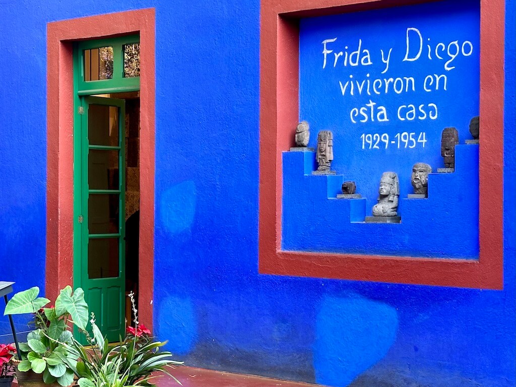 Sign "Frida and Diego lived in this house" on wall of Frida Kahlo museum