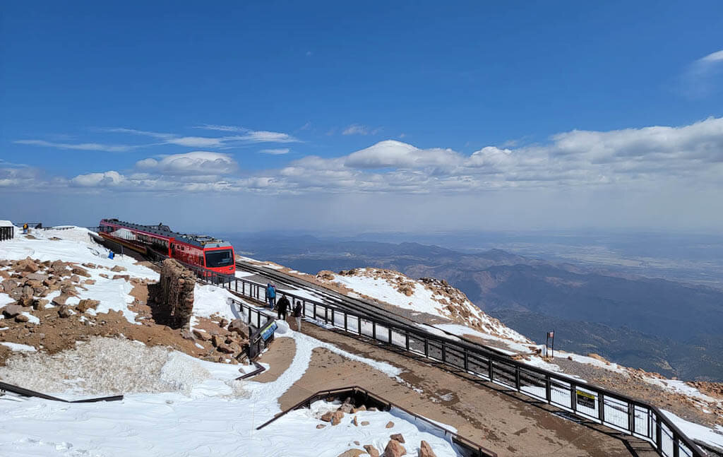 Pike's Peak Cog Railway with snow and clouds