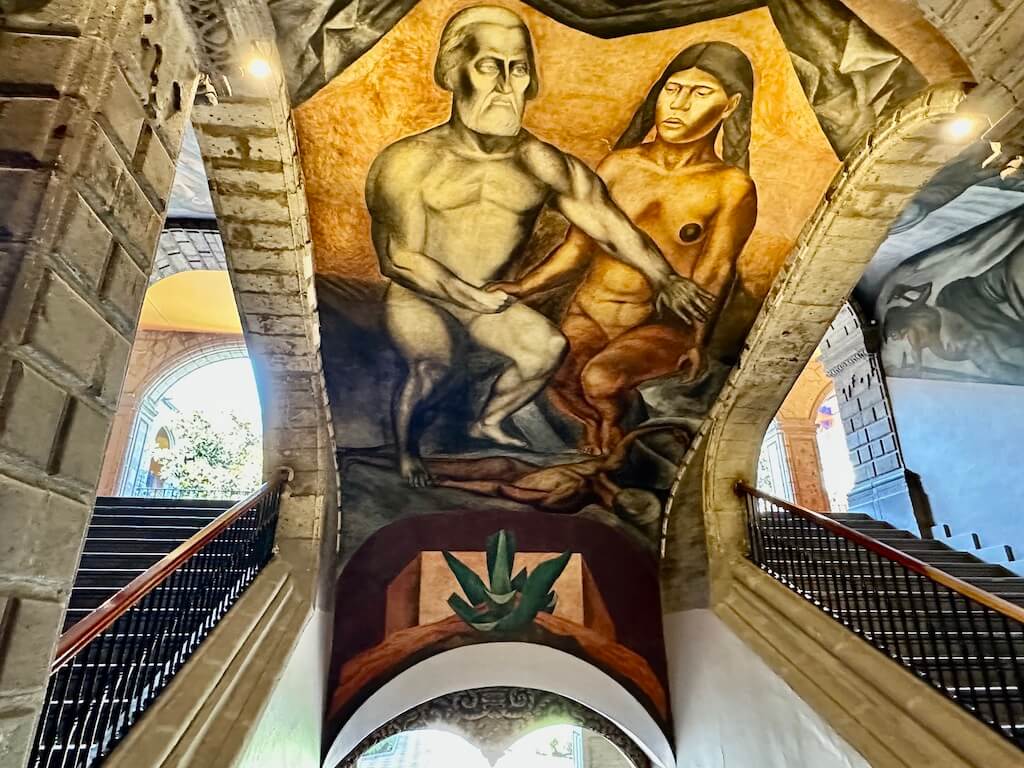mural of man and woman between two staircases