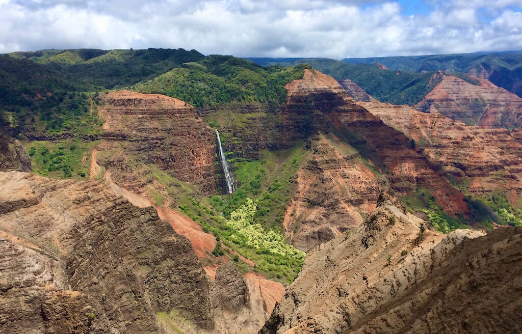 View of Waimea Canyon and waterfall, top Kauai travel tip
