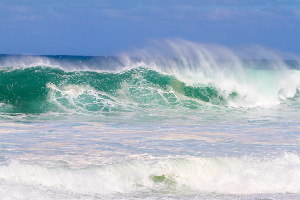 These waves are at pipeline on the north shore of Oahu during the winter in a huge storm.