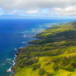 lush green coastline of Maui as seen from a helicopter