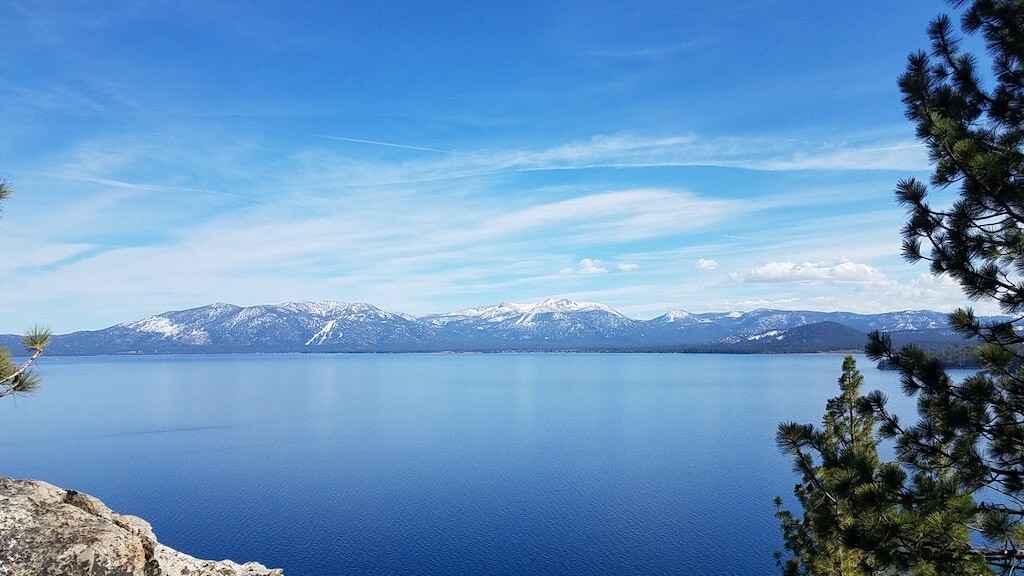 View of snow-capped mountains across beautiful blue Lake Tahoe, California, USA