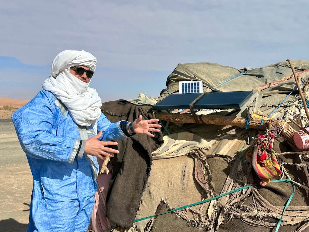 man in front of nomadic Berber tent