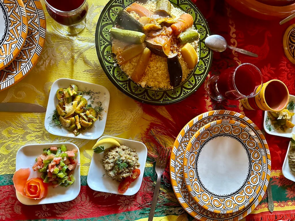 dinner table of moroccan tagine and salads
